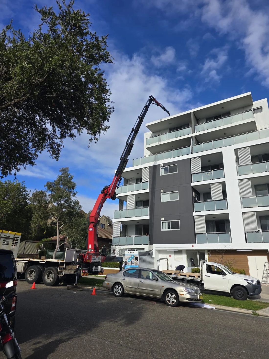 Level8 crane at work beside a multi-storey apartment block