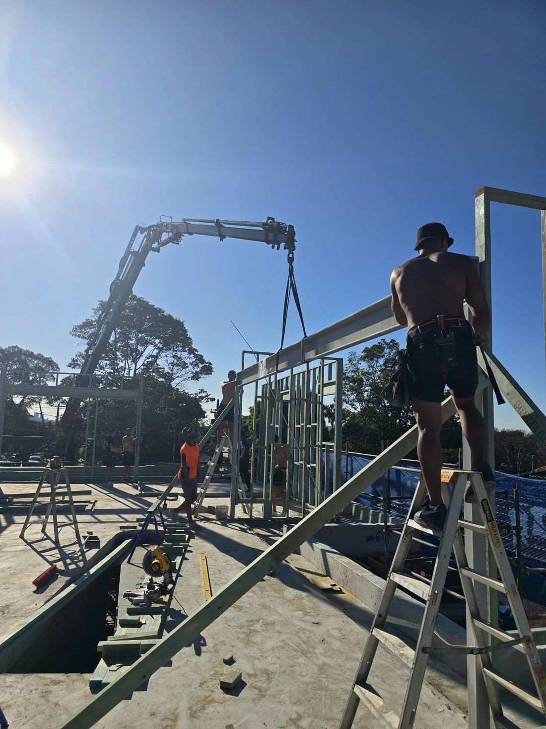 Crane placing wall frames on a building site